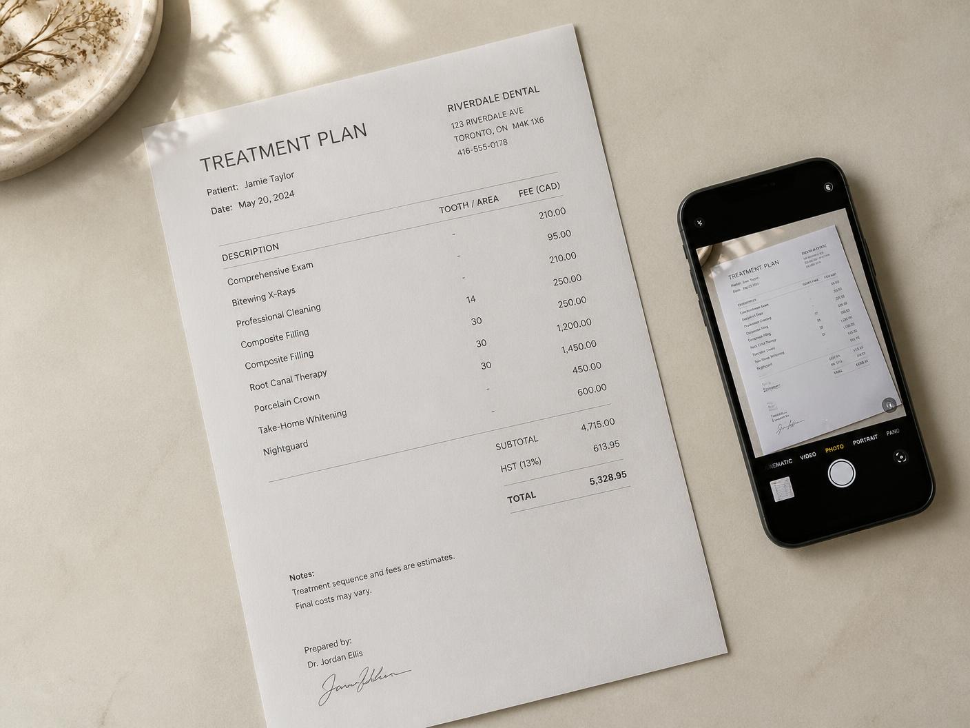 A printed dental treatment plan on a desk being photographed with a phone